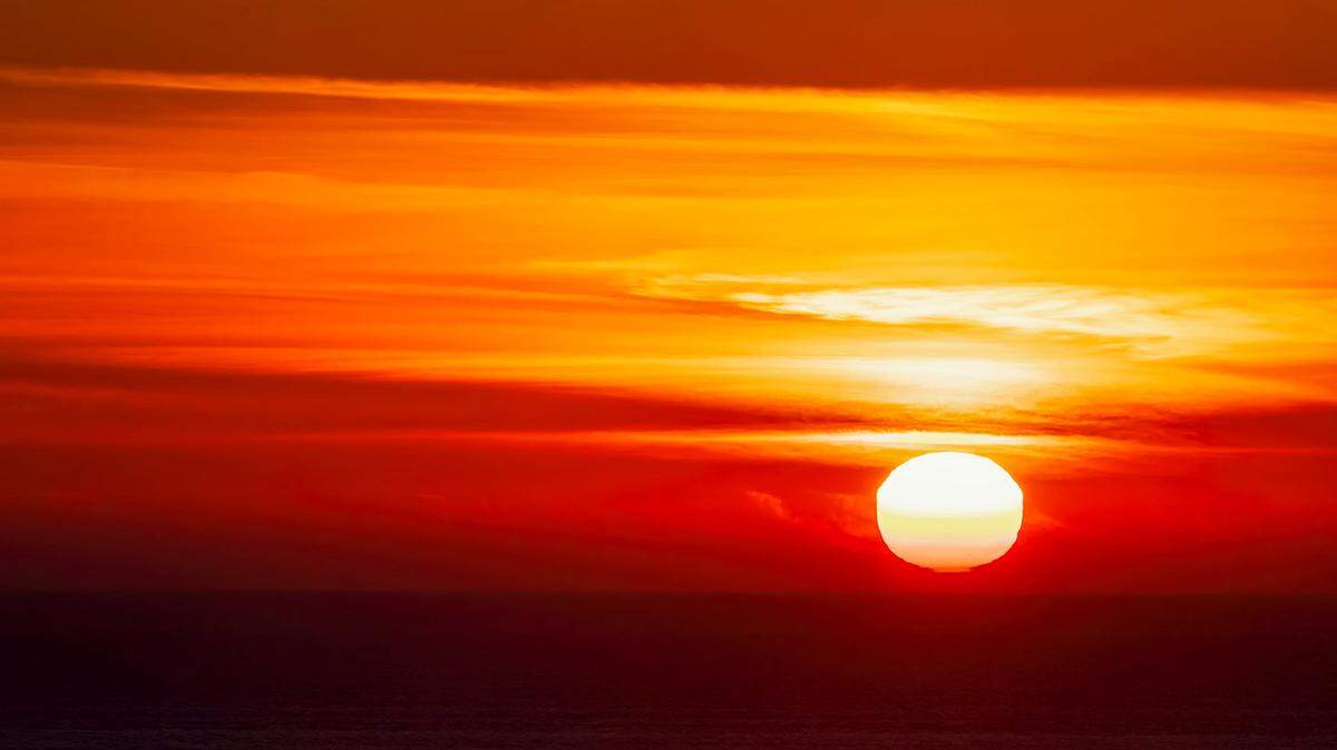 The sun hovers just above the horizon before setting in a blaze of orange and red in a view from Montana de Oro this week.