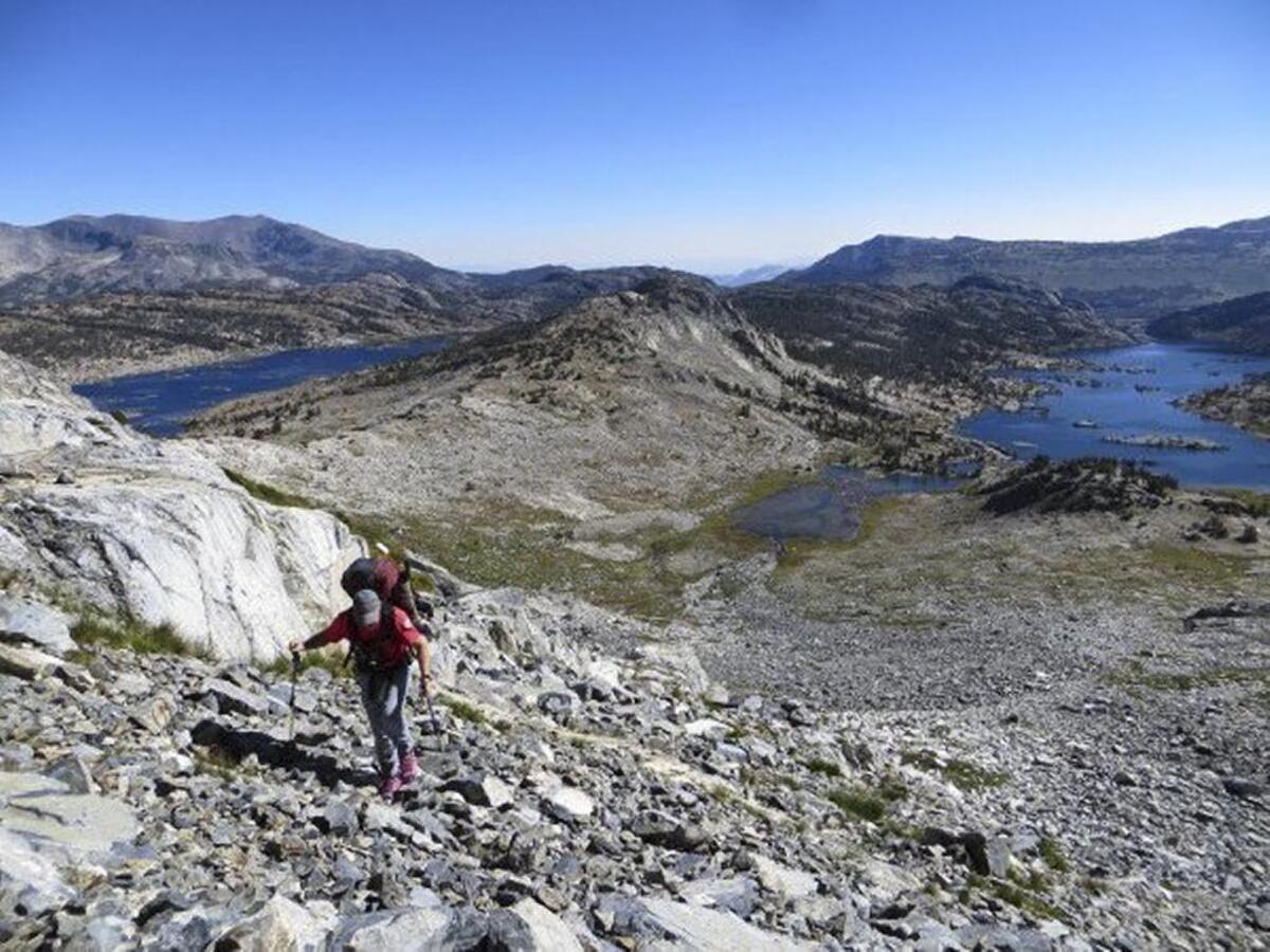 Dean Rosnau begins ascending the lower slopes below the east face of Banner Peak in the Ritter Range in the Sierra Nevada mountains, where he’s spent more than four years searching for a missing Pennsylvania climber. Garnet Lake can be seen in the background on the right, and Thousand Island Lake is on the left.