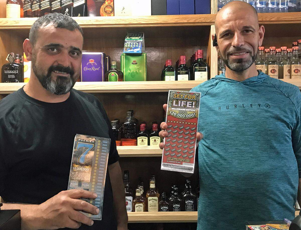 Sean Farhoud, general manager of the Cambria General Store, left, and store co-owner Benan Akkare hold California State Lottery tickets on Wednesday, Sept. 13, 2023. Farhoud sold a California lottery Scratchers ticket worth $5 million on Aug. 9, 2023.