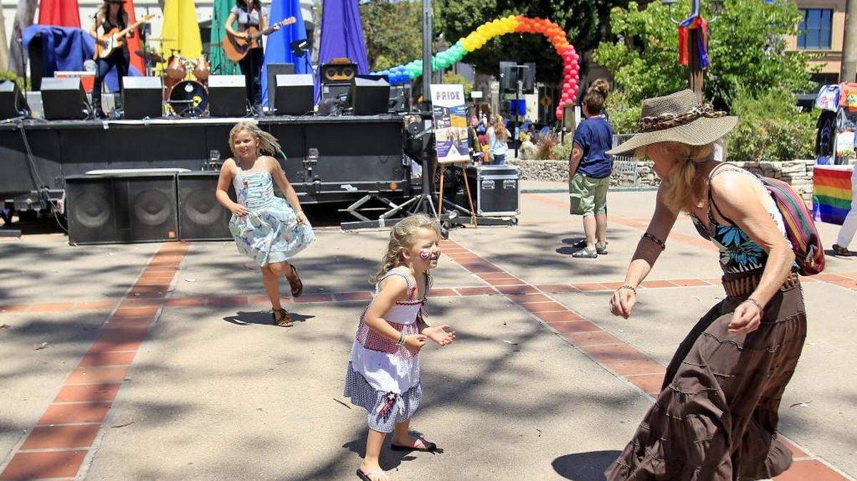 Abby Sims, 7, left, and sister Shelby Sims, 4, of San Rafael, dance up a storm with Robin Anderson of San Luis Obispo.
