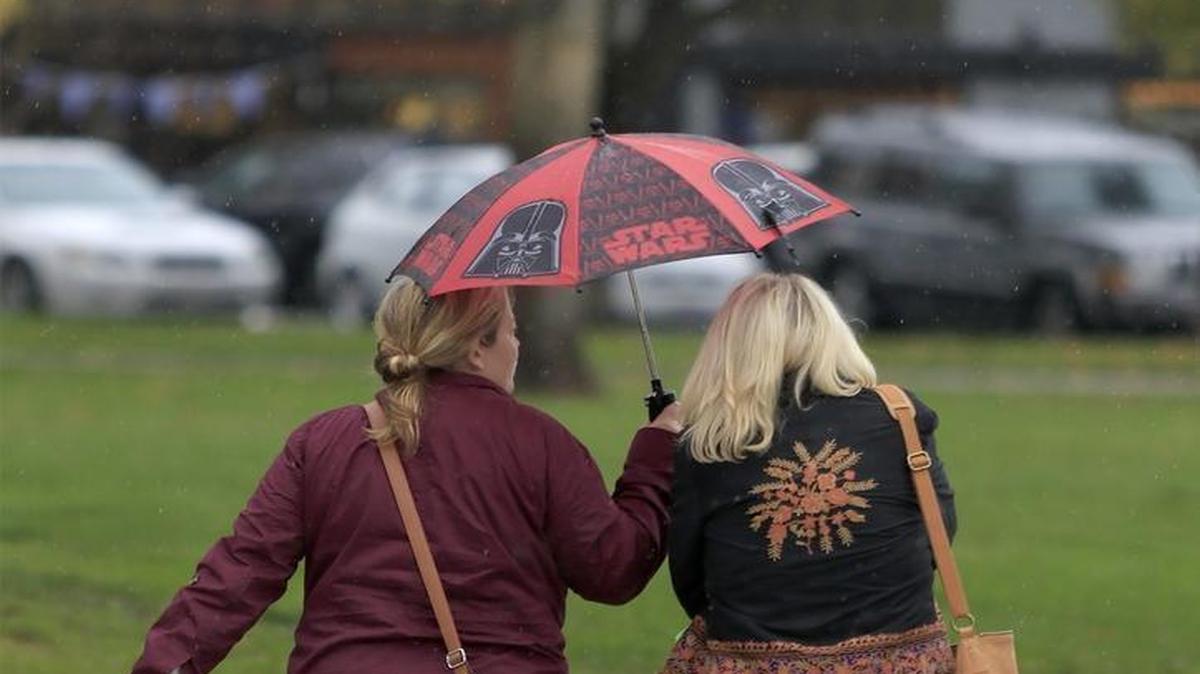 Two women share an umbrella while walking in light rain next to City Park in Paso Robles on Nov. 26. The National Weather Service said San Luis Obispo County could see a few days of rain beginning Thursday, Dec. 6, 2016.