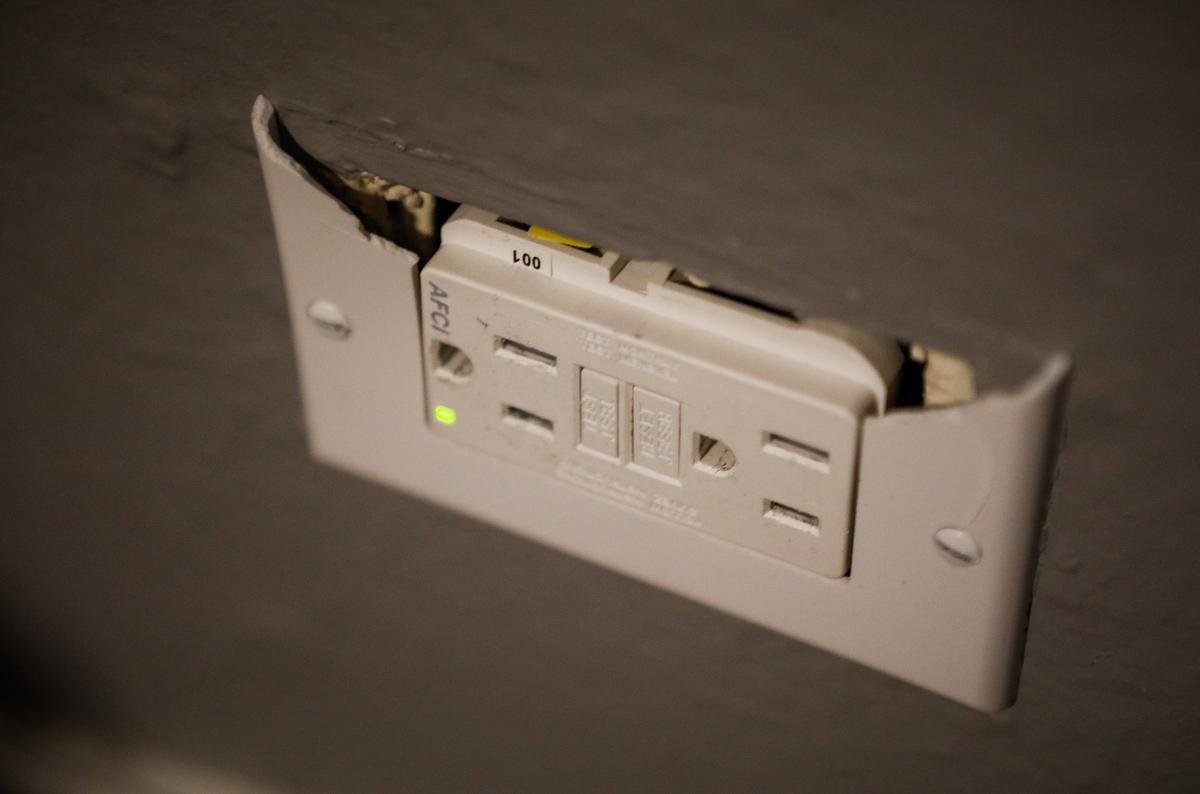 A broken outlet inside of a college student’s apartment at The SLO Student Living complex near Cal Poly in San Luis Obispo.