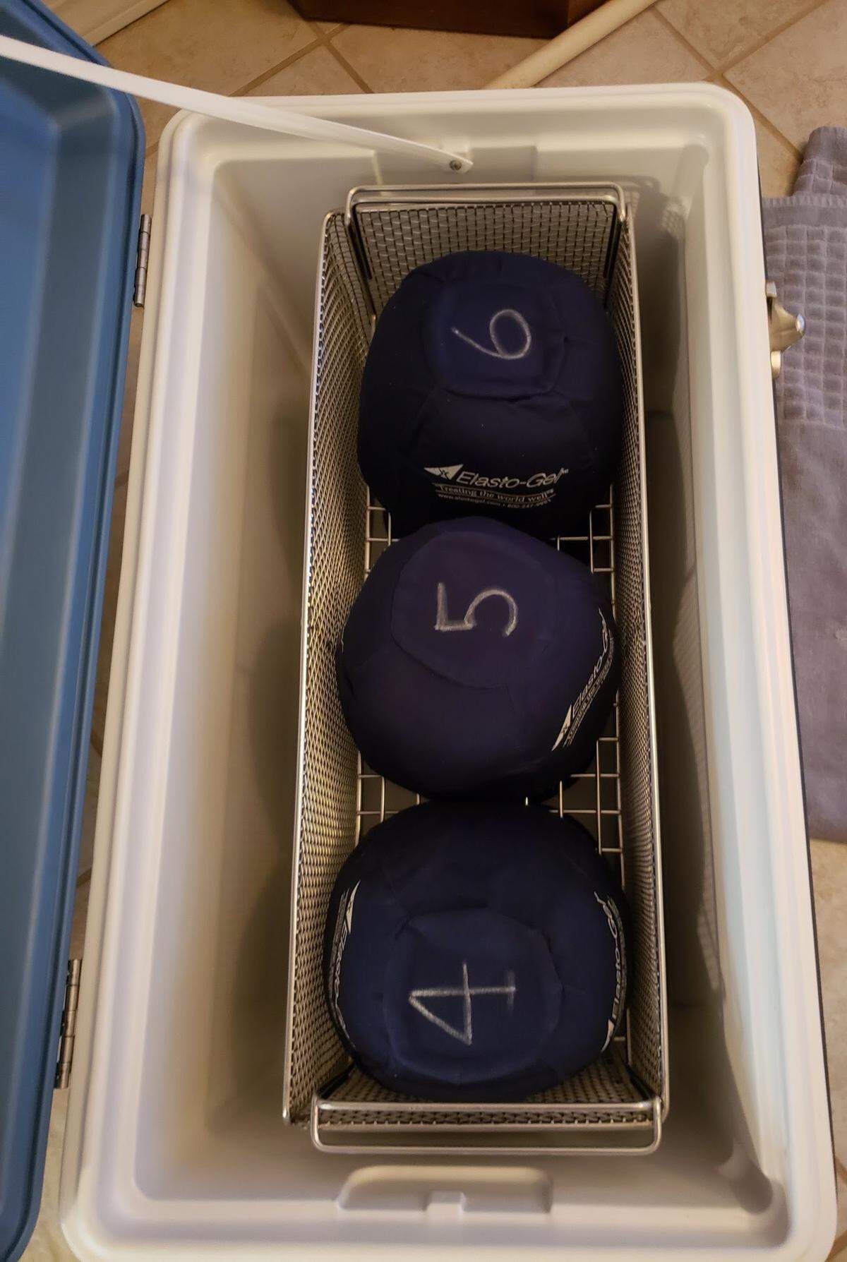 The numbered cold caps (pictured without ice) are stored in a cooler waiting for use.