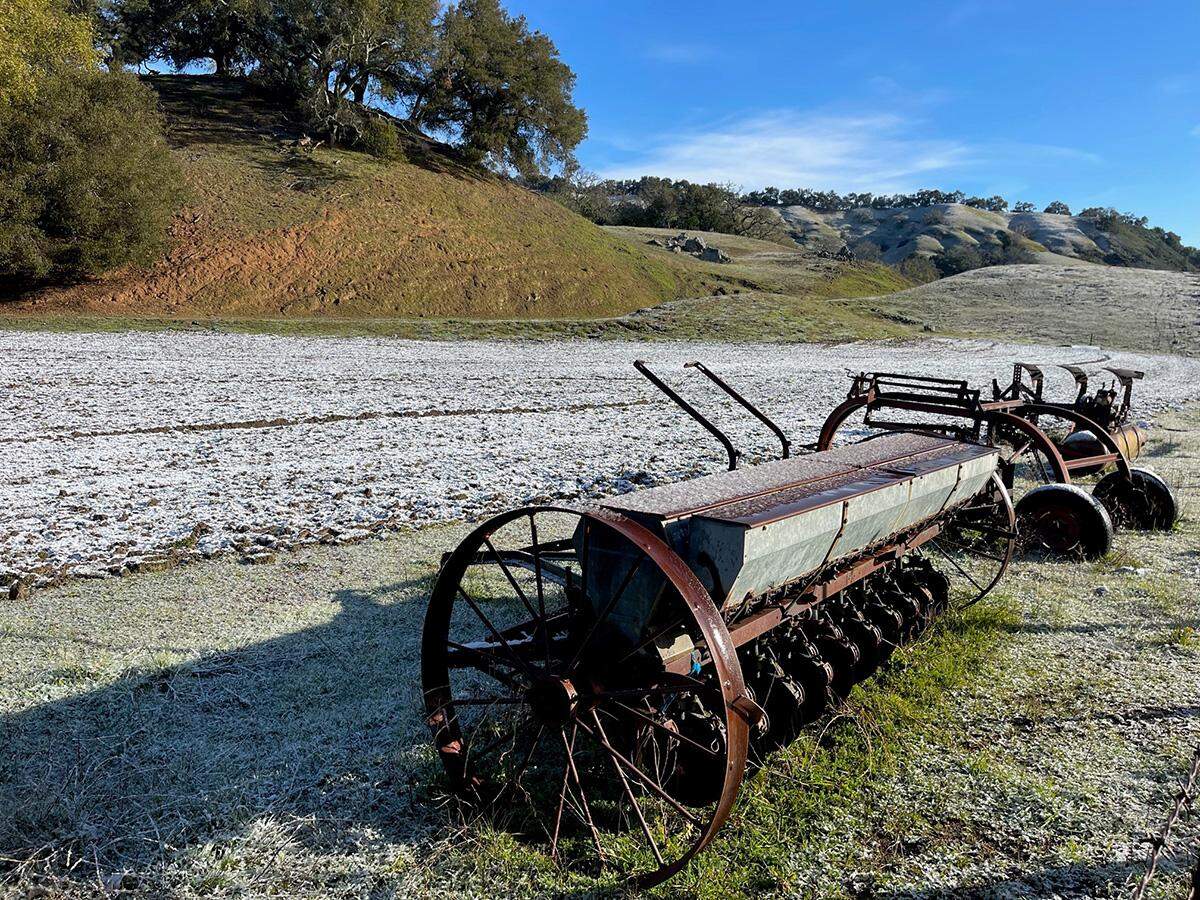 Snow dusts fields and old farm equipment on Thursday morning, Feb. 23, 2023, in the Willow Creek and York Mountain districts of west Paso Robles.