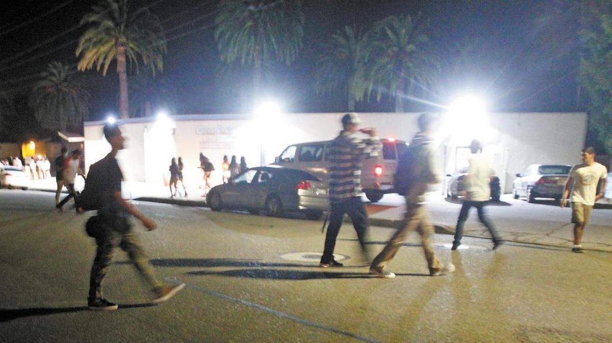 Students walk near the Campus Bottle store at Hathway Avenue and California Boulevard near the Cal Poly campus.