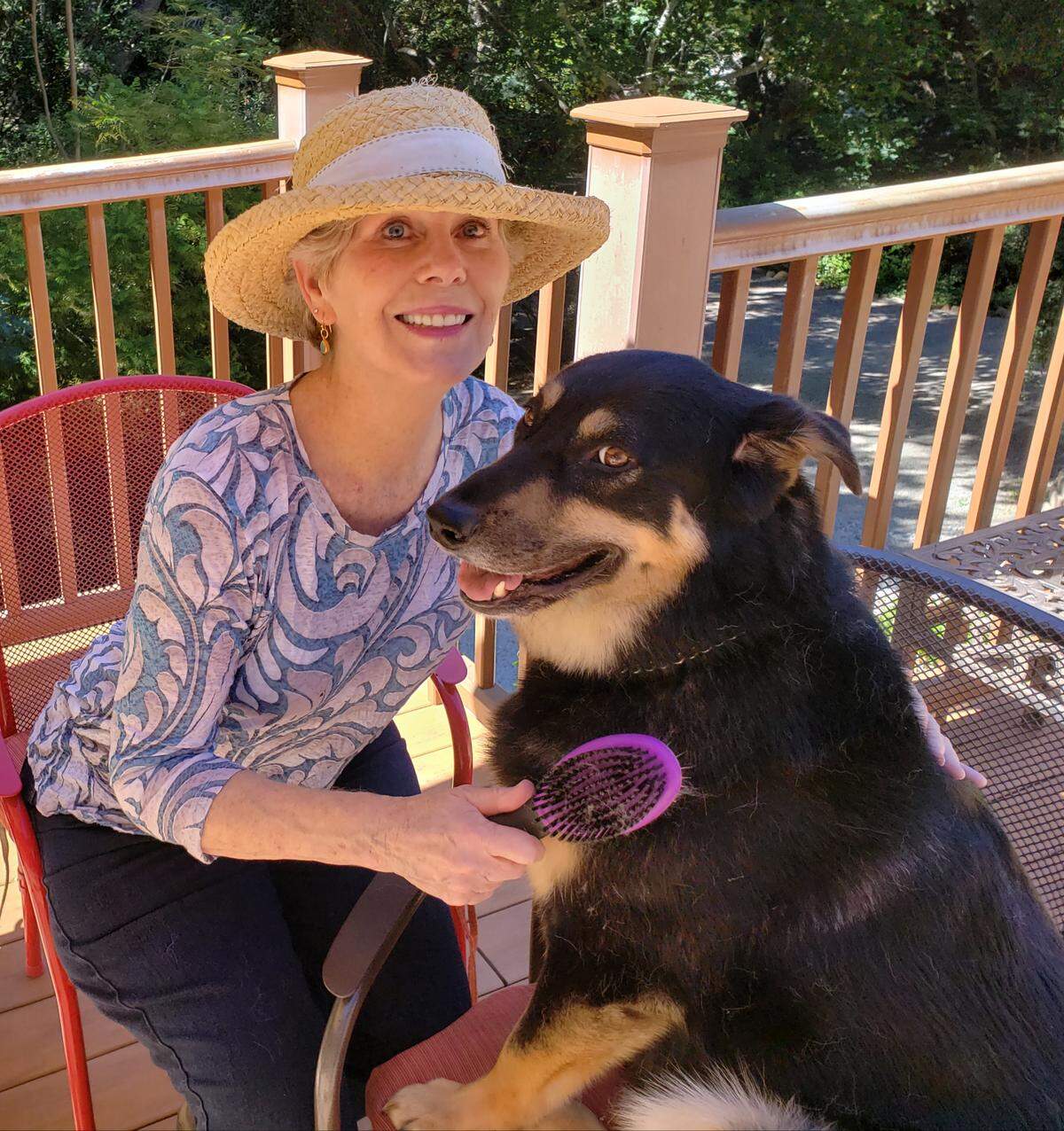 Mimi Ditchie has volunteered for a dozen years at Woods Humane Society, having begun as a way to counter her grief over her father’s death. She’s now a lead photographer for the nonprofit, and her pictures of the available animals are instrumental into introducing them to the public. She adopted the dog shown with her, Diesel, from Woods.