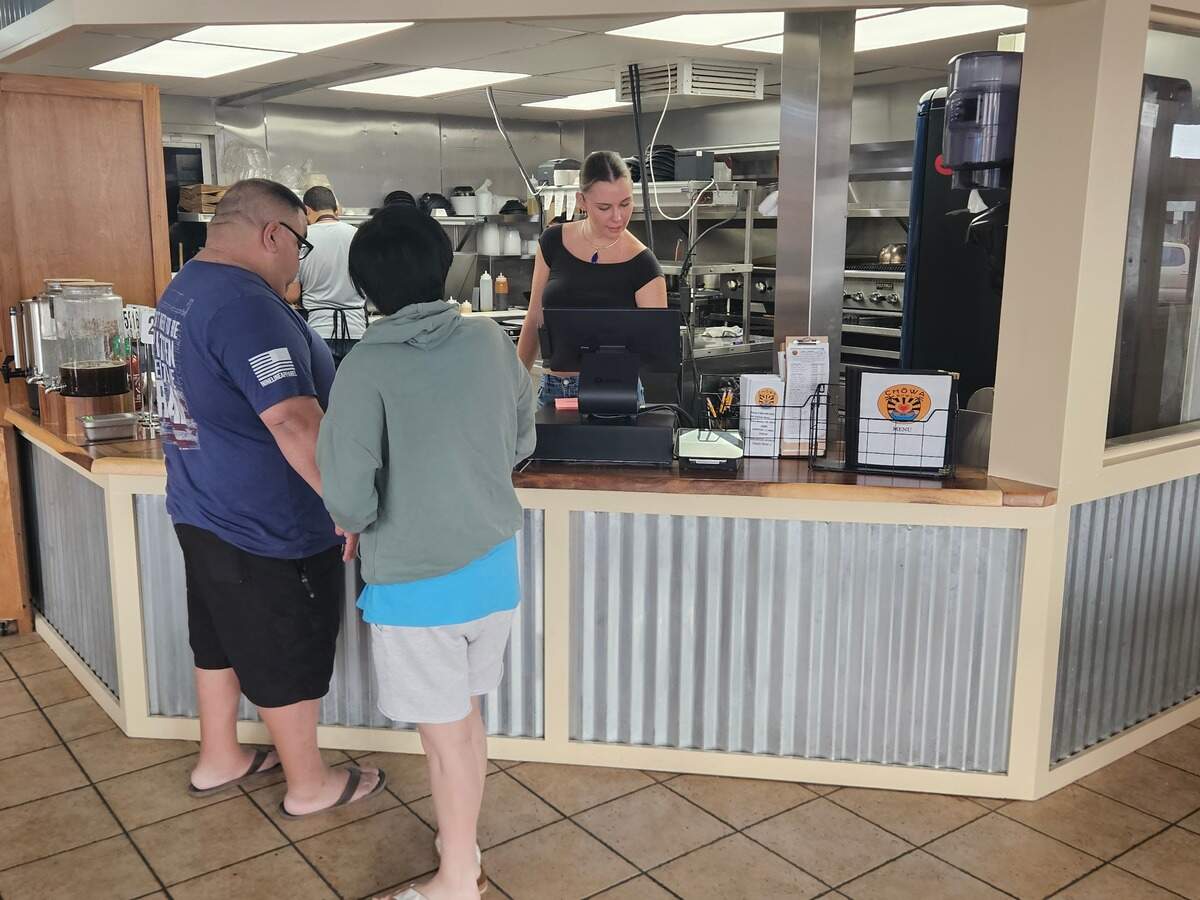 Chowa Bowl has opened a new location in Pismo Beach, serving poke bowls and ramen to visitors. Cashier Fiona Durham rings up customers. 