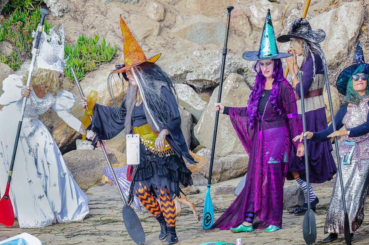 Several witches get ready to hit the water for the ninth annual Morro Bay Witches Paddle on Saturday, Oct. 22, 2022.