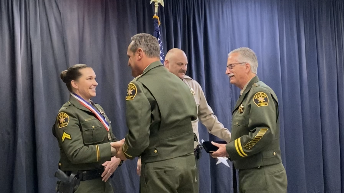 Deputy Melissa Van Horbek shakes Sheriff Ian Parkinson’s hand as she and Deputy Cory Bright accept Lifesaving Medals from Parkinson and Undersheriff Jim Voge on Thursday, April 13, 2023.