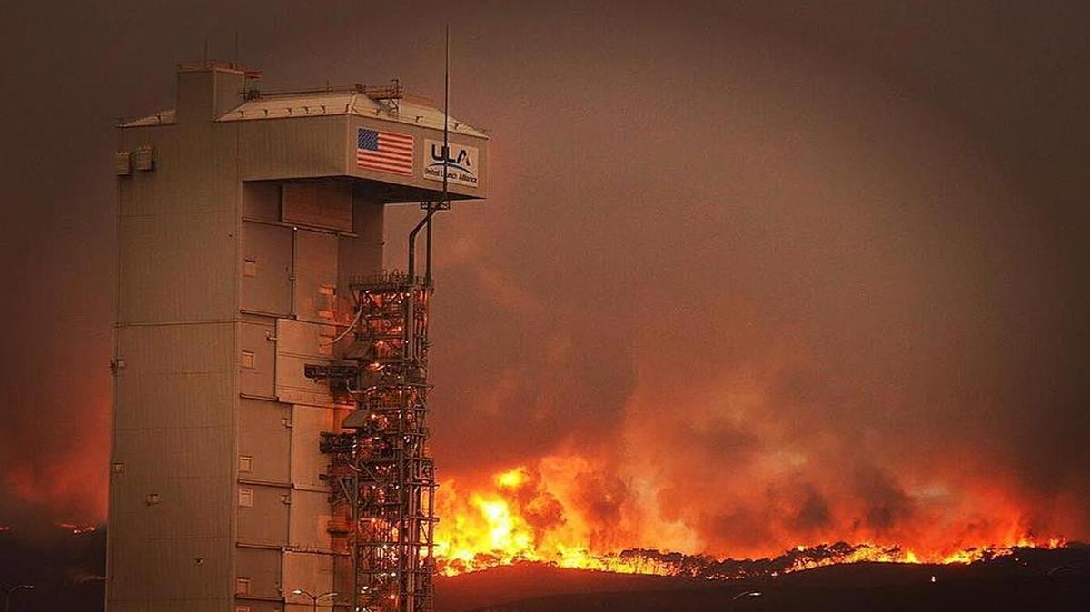 The Canyon Fire burns at Vandenberg Air Force Base behind the Space Launch Complex 3 housing the Atlas V rocket and WorldView 4 satellite.