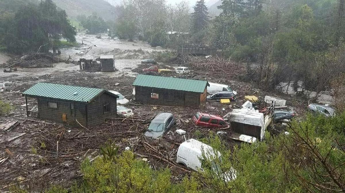 El Capitan Canyon cabins and vehicles are damaged by heavy flooding Friday morning.