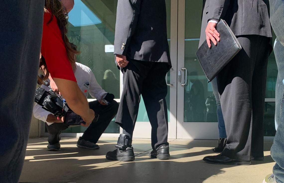 Ruben Flores’ electronic monitoring device is removed from his ankle outside the Monterey County Courthouse in Salinas after he was found not guilty of an accessory charge in the Kristin Smart murder trial, on Tuesday, Oct. 18, 2022.