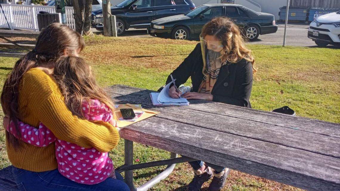 In this file photo, Karla Najera, a promotora, helps a family fill out paperwork in Sabn Luis Obispo County. The Promotores Collaborative of San Luis Obispo County has been supporting Spanish-speaking families and working with the county Public Health Department to distribute information about the coronavirus.