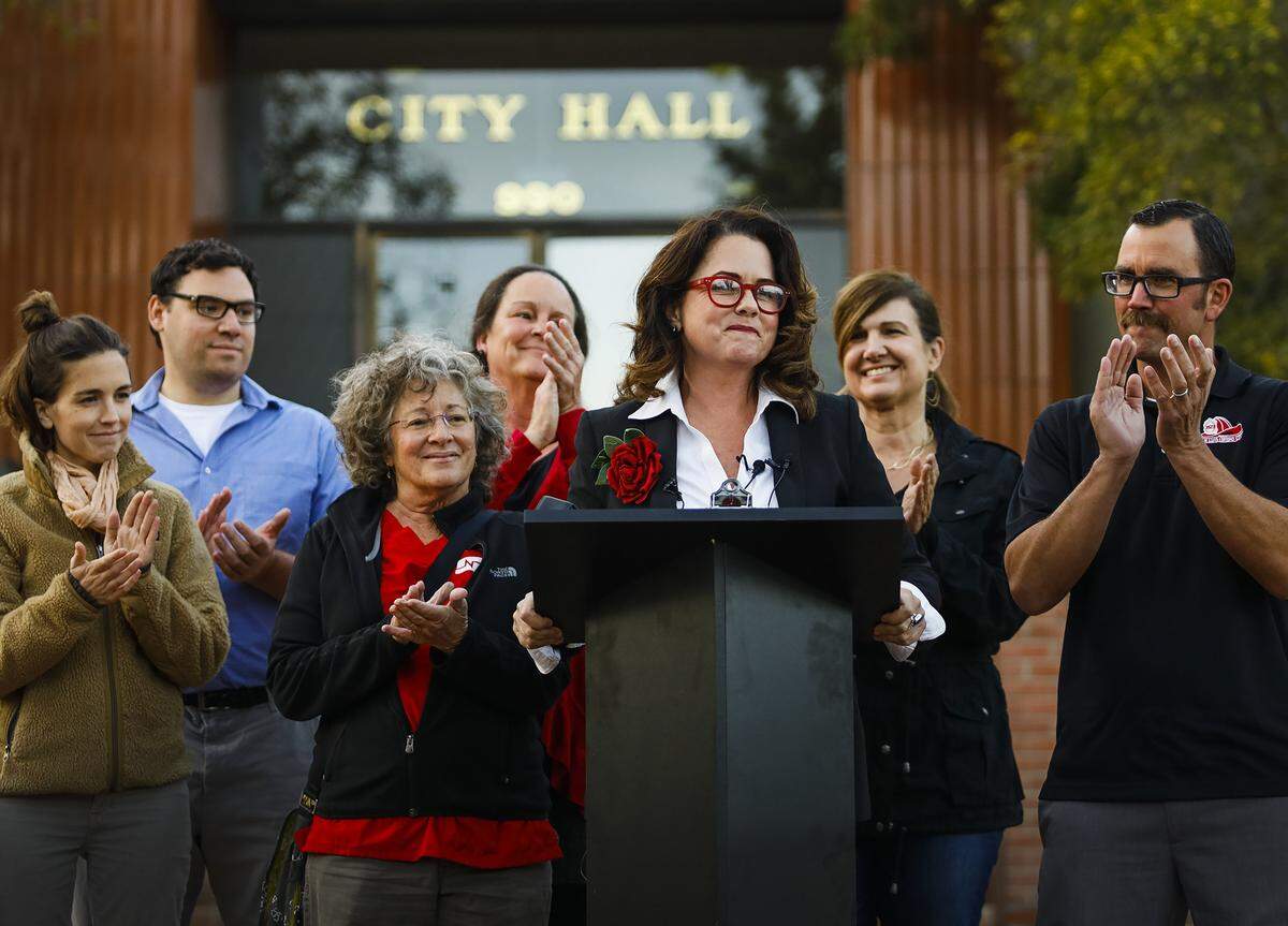 San Luis Obispo mayor-elect Heidi Harmon, surrounded by election staff and supporters, delivers an address in front of City Hall after her election in 2016.