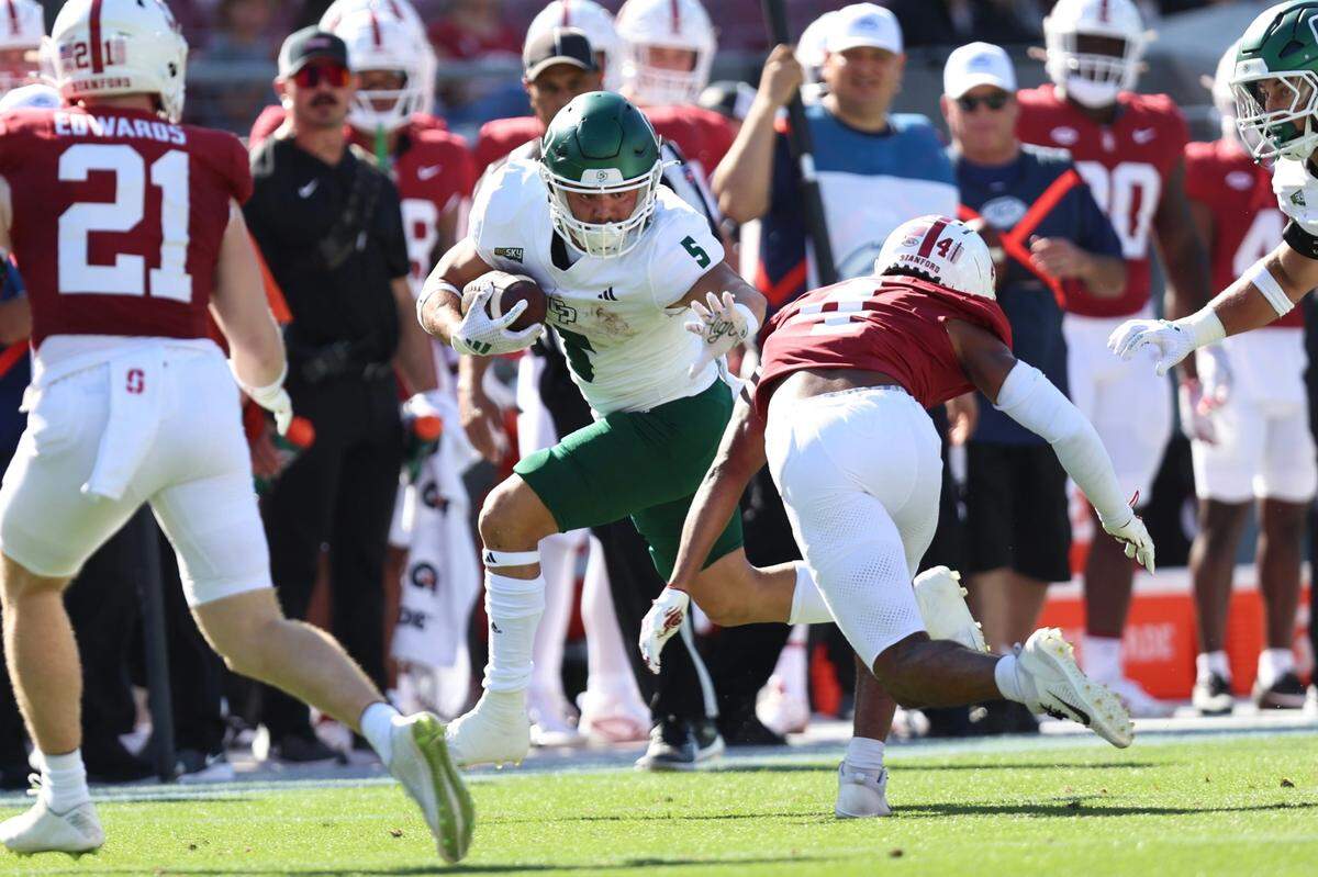 Aiden Ramos carries the ball in Cal Poly’s 41-7 loss to Stanford in a college football game on Sept. 7, 2024.