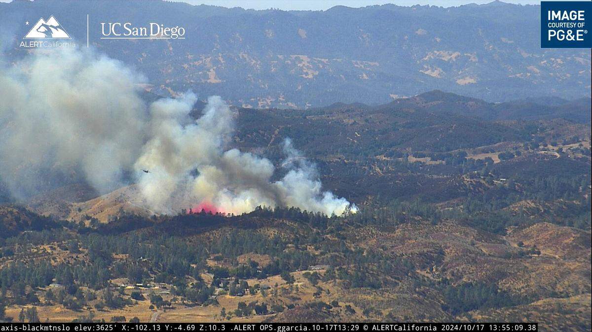 A tanker drops fire suppressant on a vegetation fire burning in eastern Santa Margarita on Oct. 17, 2024.