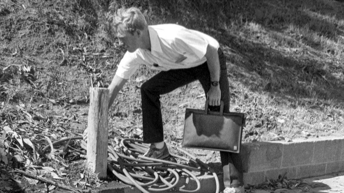 Ray Cardwell, hired to help the city of San Luis Obispo conserve water during a drought, shuts off a hose on Southwood Street on June 10, 1988.