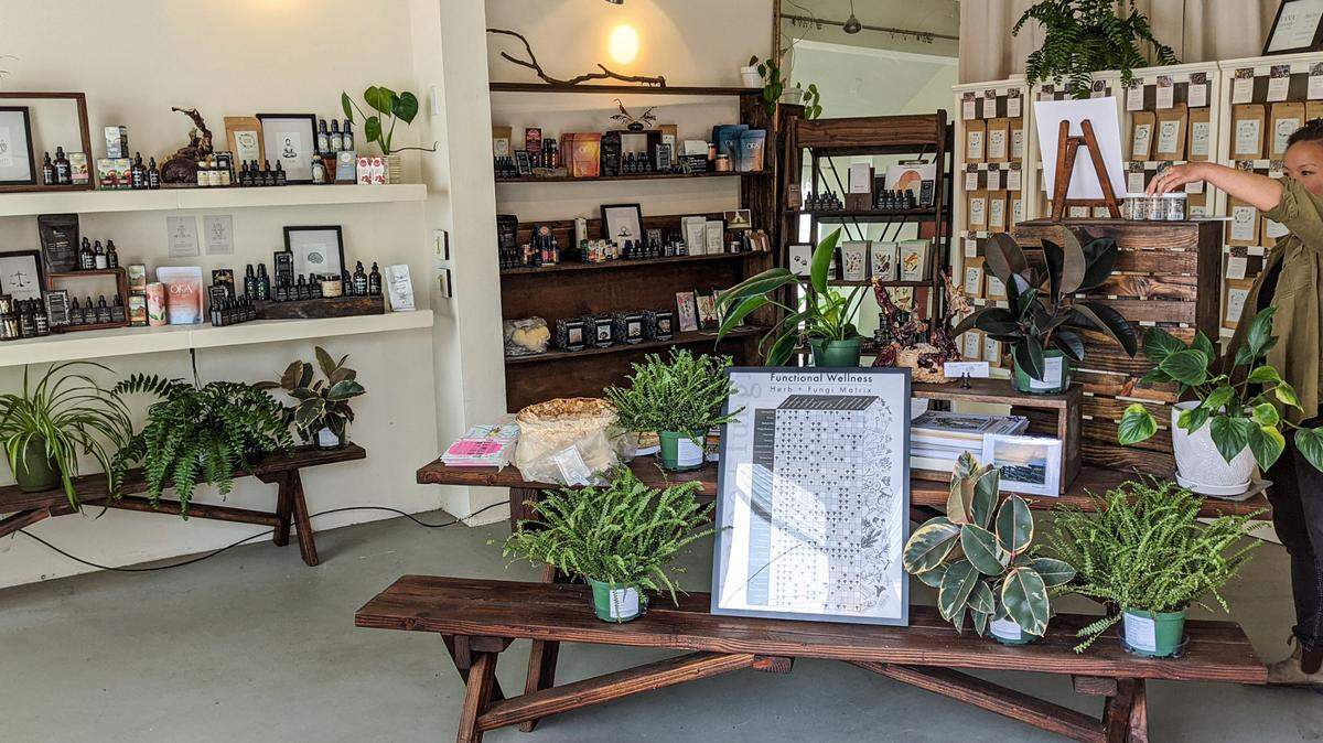 Meho Watanabe, co-owner of Plantae & Fungi in Cambria, checks the stock at the wellness store on June 24, 2022.