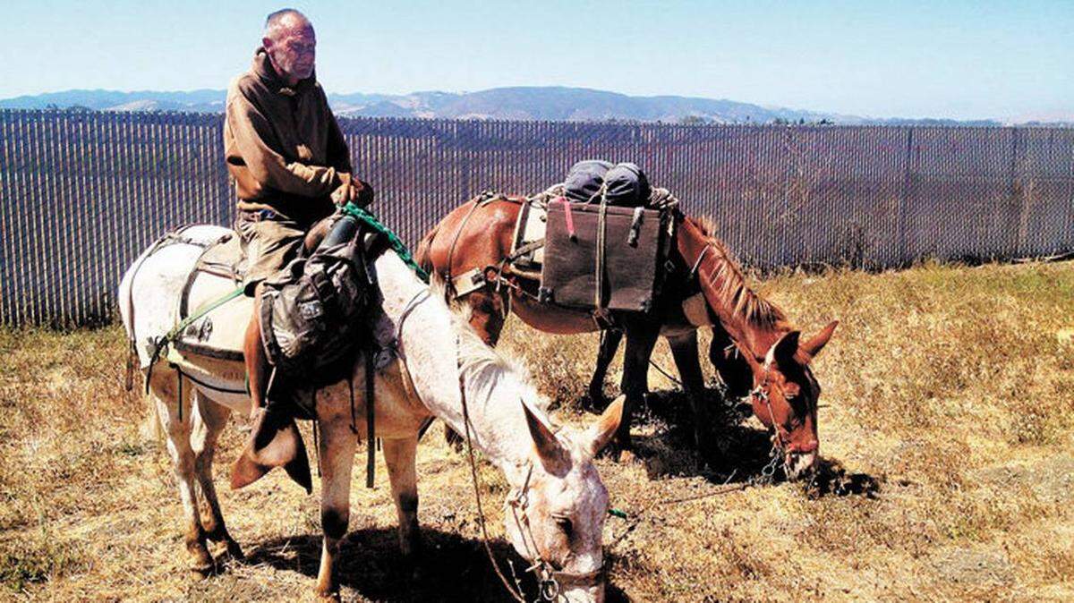 A 2012 Tribune file photo shows “Mule Man” John Sears and his mules during a visit to San Luis Obispo. Sears, a nomad and public land activist, was recently arrested on Nacmiento Lake Road for not heeding CHP officers’ requests to move off the road.