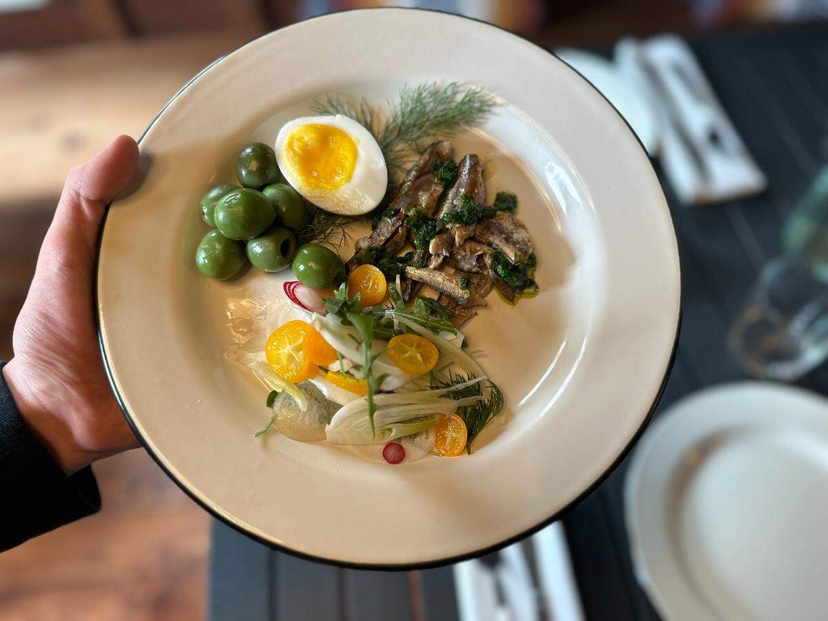 Preserved white anchovies are served with half a hard-boiled egg and a fennel and radish salad as one of several small plate offerings at Brydge restaurant in Cambria.