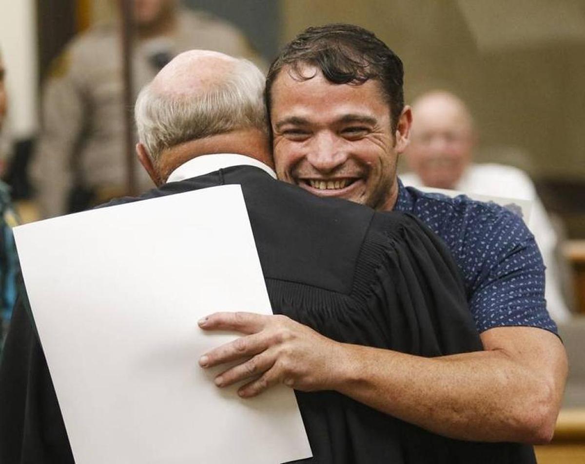 Judge John Trice receives a hug from Andrew Phillips as Phillips graduates from San Luis Obispo County’s Veterans Treatment Court in June 2016.