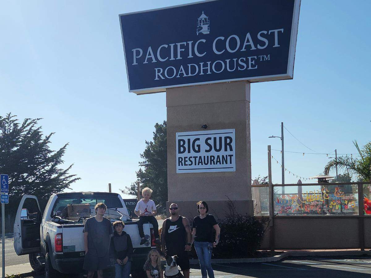 A North Coast family that’s facing homelessness after living for 12 years in a Cambria house paused to catch their breath during their hasty departure from their temporary home in two motel rooms after they were evicted late on July 20. From left, they are Aiden Pacheco, 18, Anthony Capossele, 13, Blake Oxley, 10, Annalise Oxley, 7, mom Diana Suhovich, 42, dad Thomas Oxley, 41, and their 15-year-old dog, Zeus. The family has been searching for permanent housing for months.