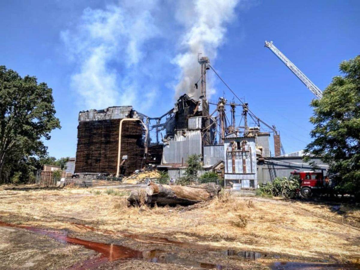 The ruins of the Templeton Feed & Grain building smolder on Saturday, July 5, 2025, in a view from the back side of the building, which was gutted in a devastating blaze that start late on the Fourth of July.