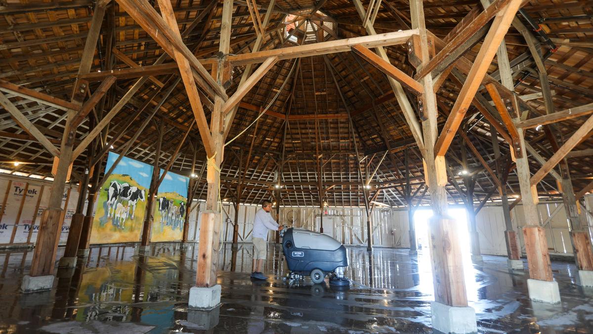 José Corona with Coastal Janitorial scrubs the floor of the Octagon barn before Saturday’s grand opening. The Land Conservancy of San Luis Obispo County restored the facility, which is about to open as a museum/venue after years of work.