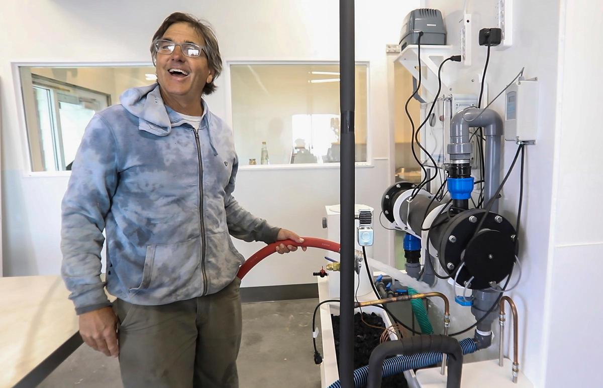 Grassy Bar Oyster Co. founder and owner George Trevelyan adds water to his new filtration system. The operation will allow the business to raise oysters separately from their beds in the Estuary.