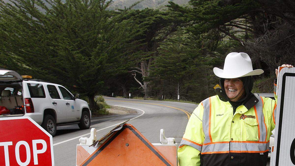 Arleen Guzzie works the roadblock at Ragged Point on Highway 1, stopping traffic from traveling toward the Mud Creek Slide just north of San Luis Obispo County, on the Big Sur coast on Thursday, May 25, 2017.
