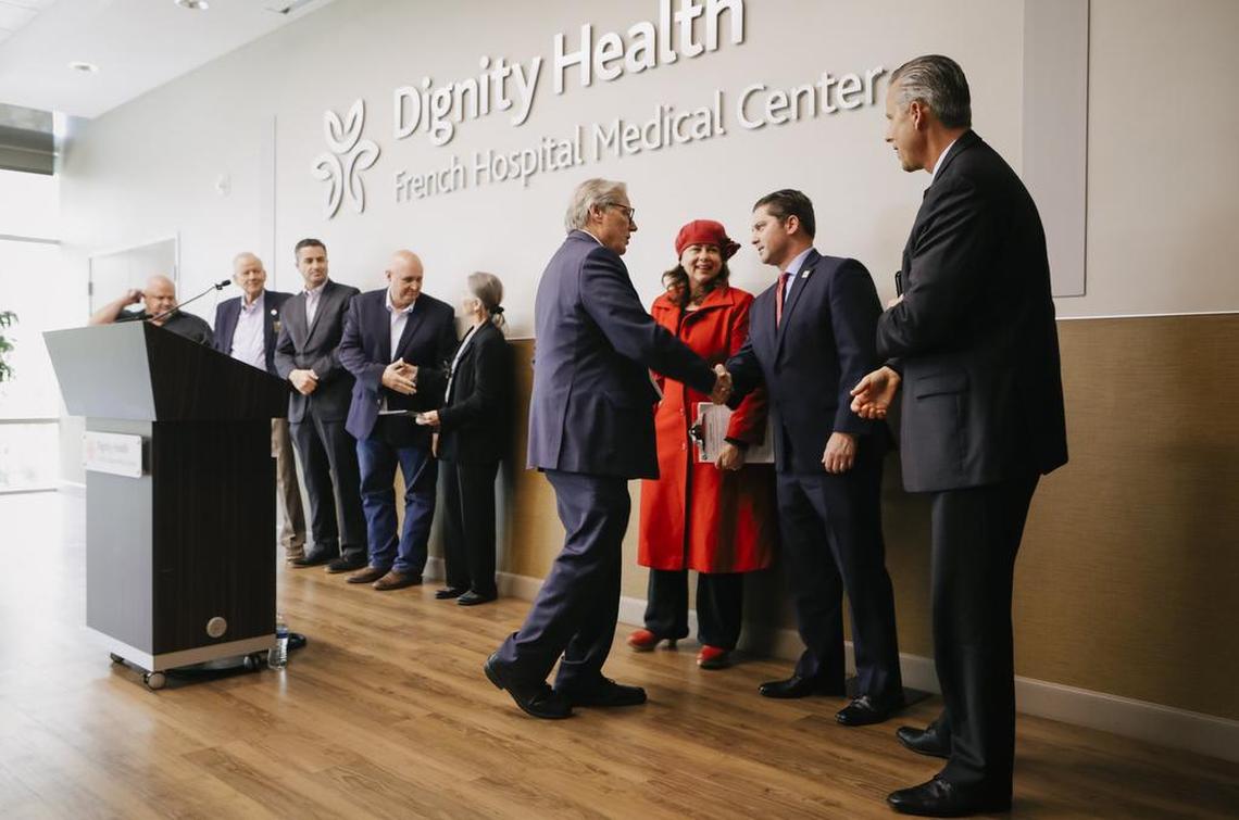 Senator Bill Monning, center, shakes the hand of Assemblyman Jordan Cunninghanm after they announced jointly-authored legislation to help mitigate the regional impact of the Diablo Canyon nuclear power plant closure.
