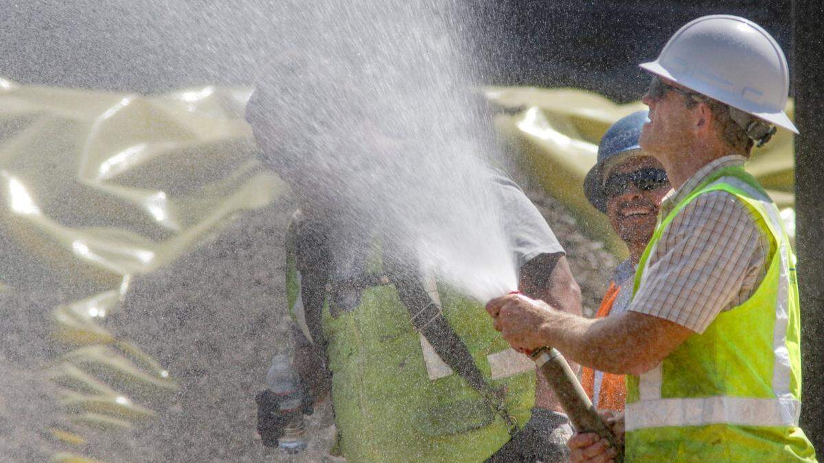 David Ruble would give his co-workers a quick spritz if they asked for it in the heat of the day. Workers at the new San Luis Obispo High School tennis courts were spraying water down to compact sand in advance of pouring concrete and setting out reinforcing bar. 9-27-2016