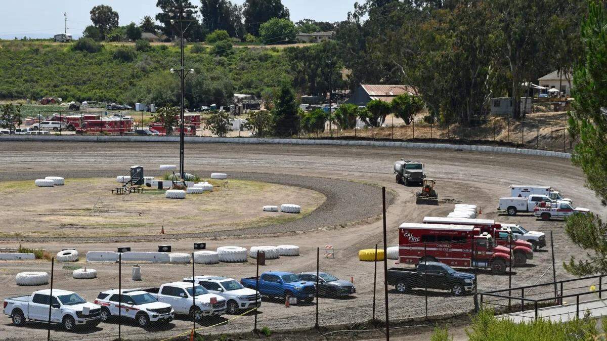 The dirt oval at the Santa Maria Raceway serves as a parking lot for the firefighting vehicles as the Lake Fire leads to a second base camp.