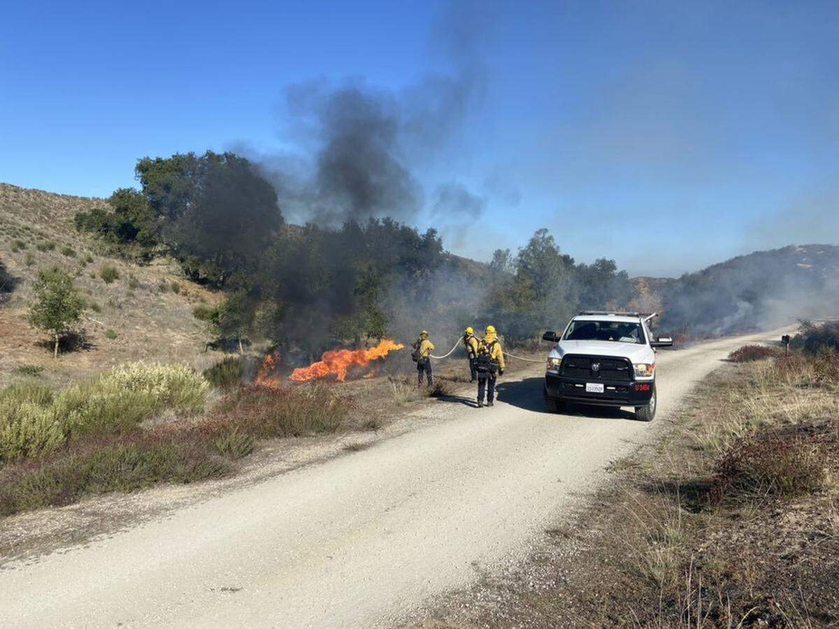 Cal Fire officials conduct a controlled burn near Creston on Wednesday, Dec. 8, 2021.