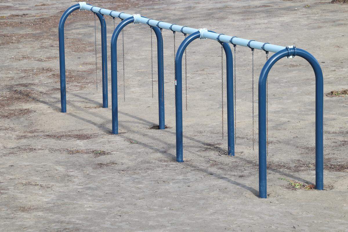 A swing set on Pismo Beach has only its chains left after heavy surf and high tides in the last week of 2023 damaged equipment, seen here Jan. 3, 2024. The waves had fully exposed the swing set’s concrete foundations before city workers filled in the sand this week. The equipment will cost $25,000 to replace.