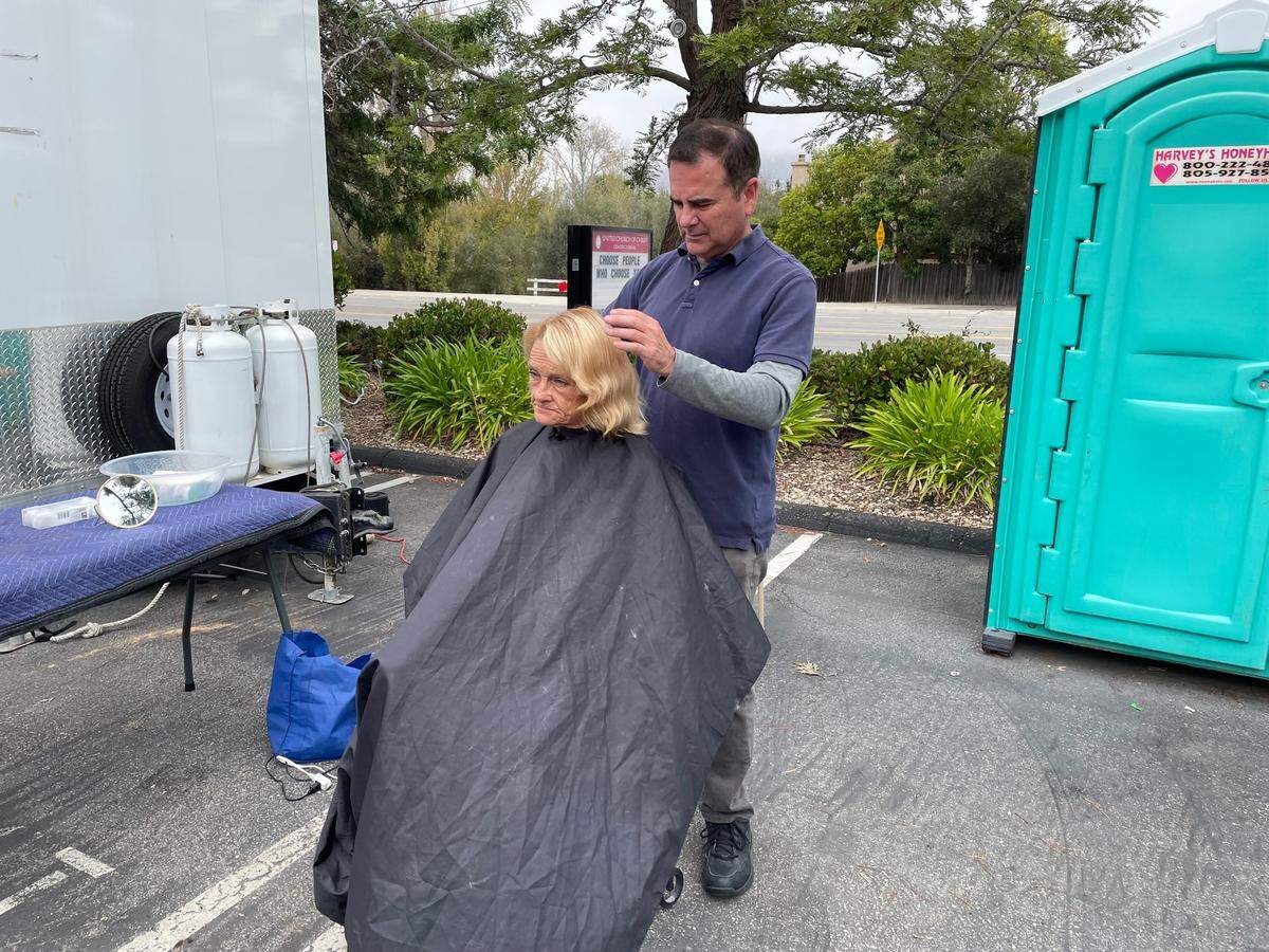 Deborah Ives gets a haircut from Hope’s Village of SLO’s pop-up care site in SLO at the United Church of Christ in November. The program offers showers and other services on Saturdays between 9 a.m. and noon at 11245 Los Osos Valley Road