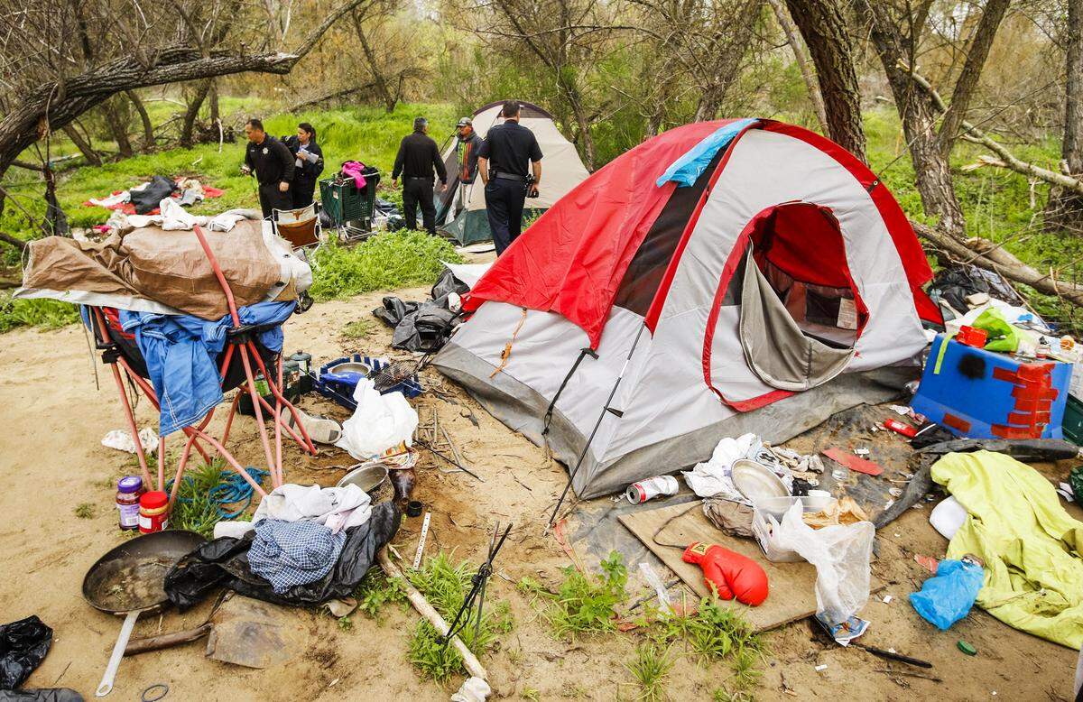 Members of the Paso Robles Police Department make contact with people living in a homeless camp along the Salinas riverbed to warn them of an upcoming cleanup in 2016. Both Supervisor Adam Hill and challenger Stacy Korsgaden have plans to deal with homelessness in San Luis Obispo County.