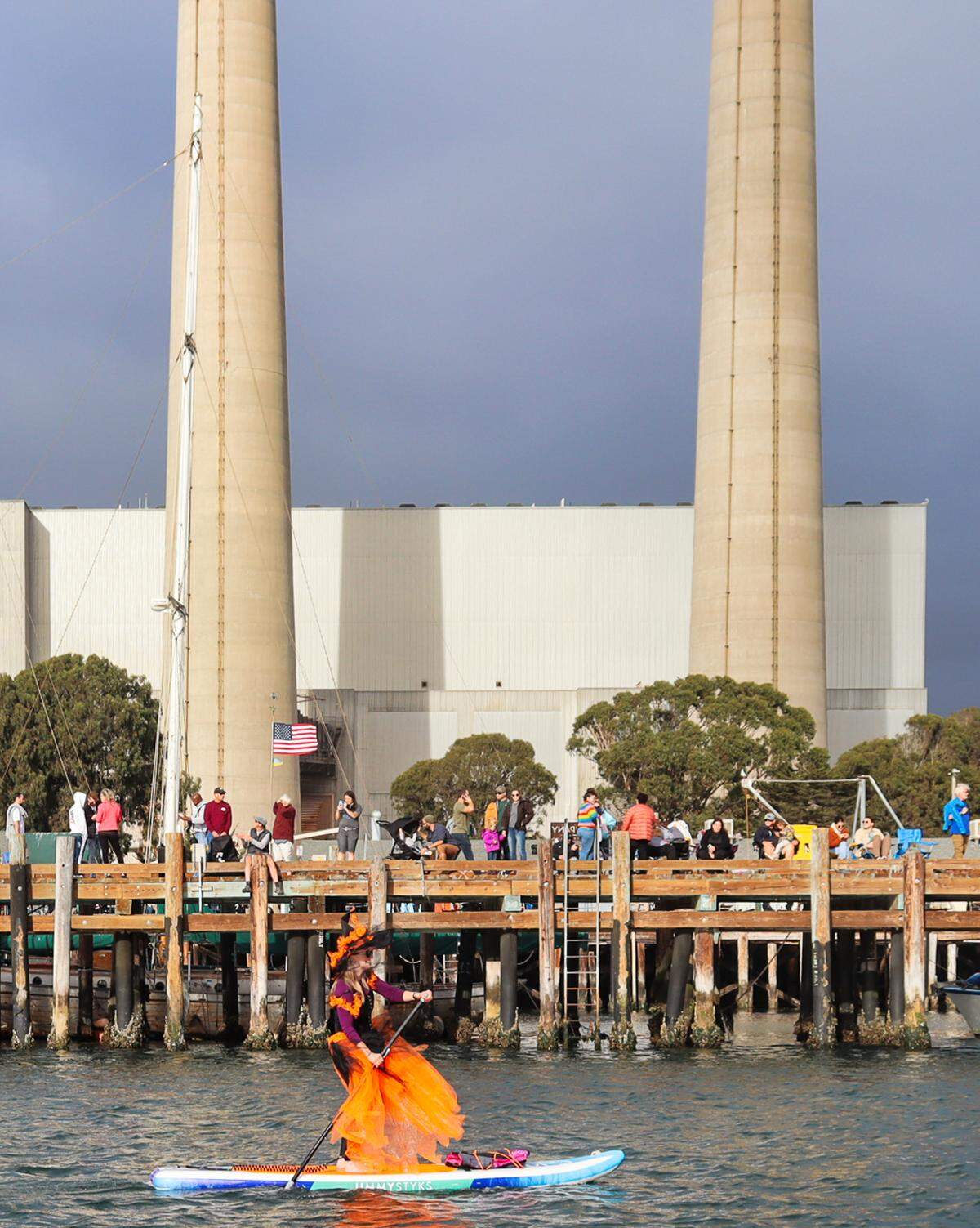 People dressed as witches and warlocks participate in the ninth annual Morro Bay Witches Paddle on Saturday, Oct. 22, 2022.