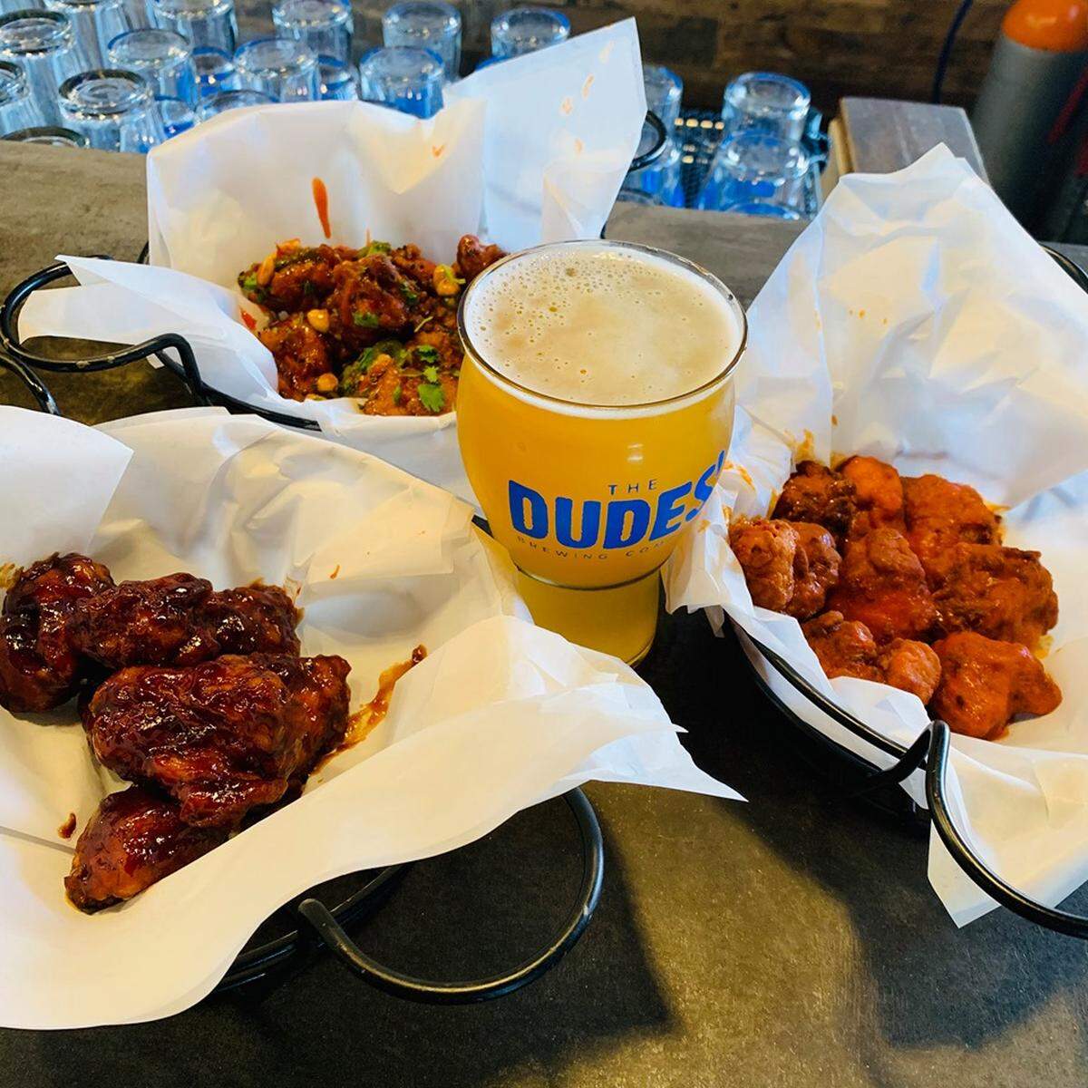 Sweet Lew’s chicken wings are paired with beer from The Dudes’ Brewing Co. in Southern California.
