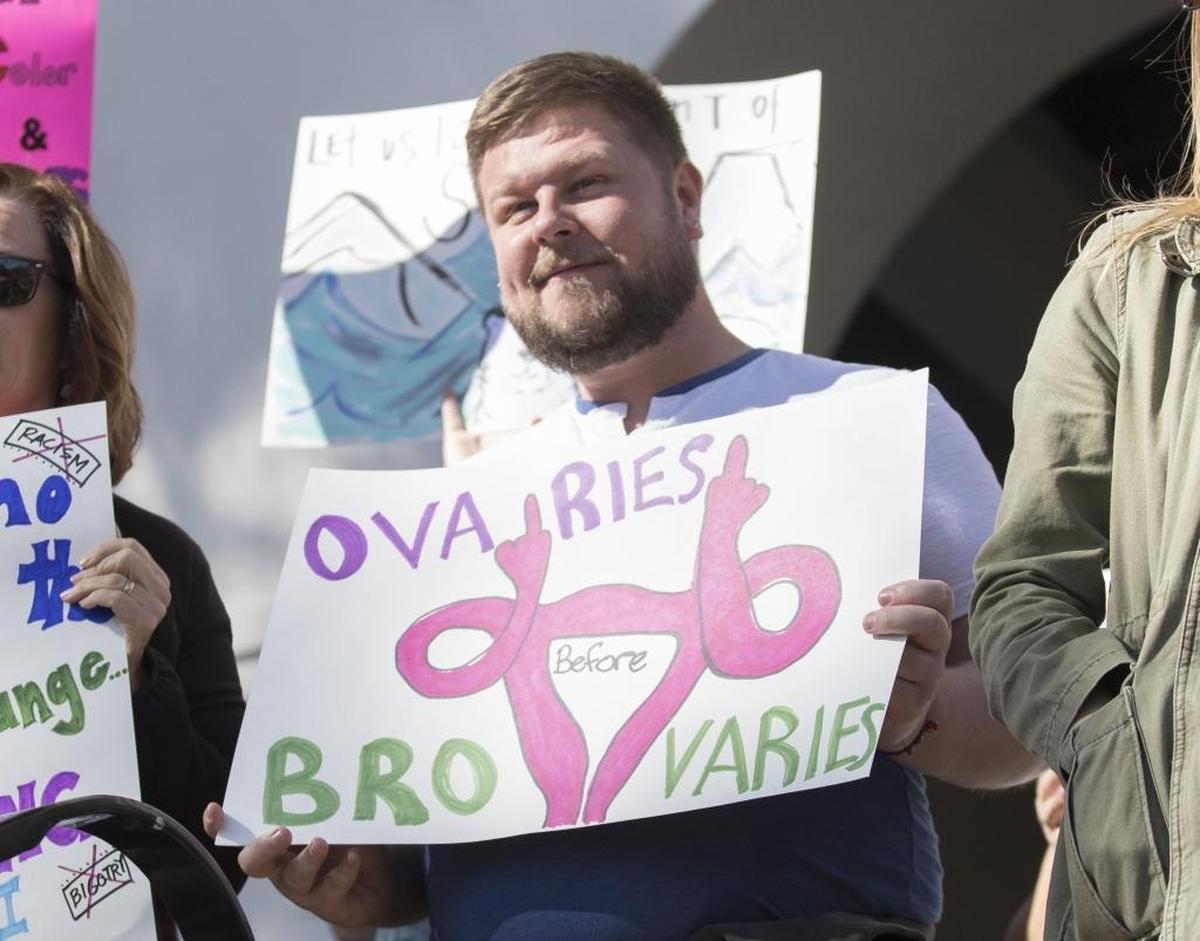 Signs from Saturday’s “Hear Our Vote: Voices of Resistance Rally.” Dustin Wagner of Denver holds his sign in front of the Mission.