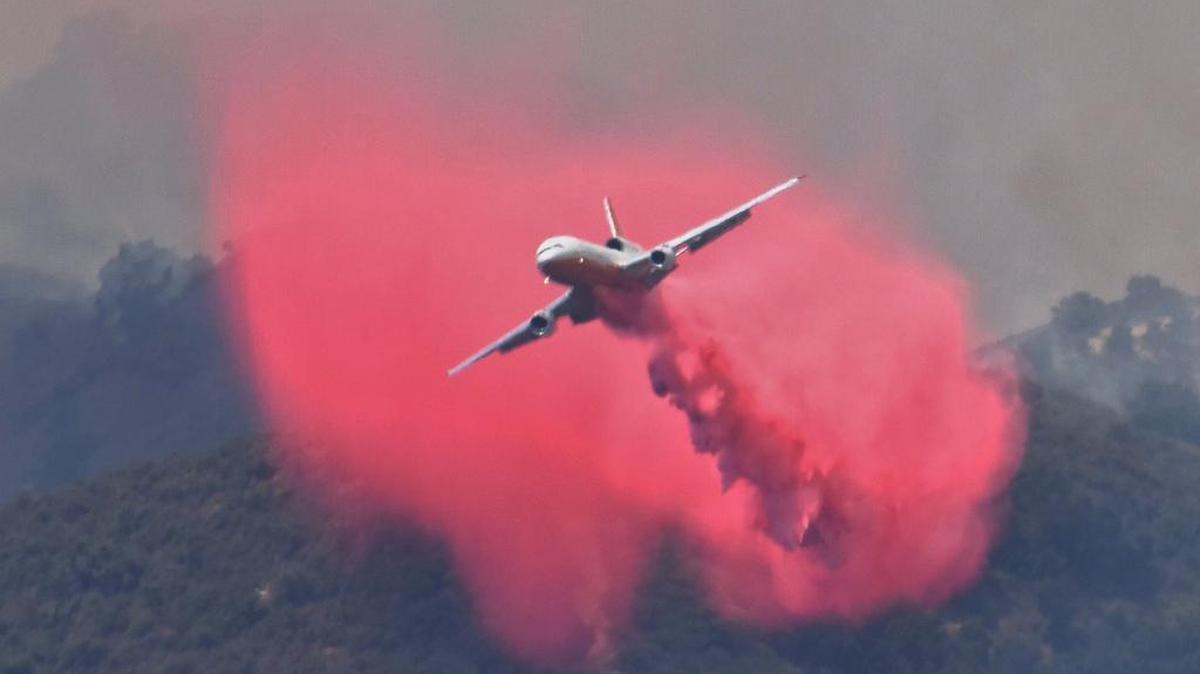 A DC-10 makes a fire retardant drop on a ridge line along the eastern flank of the Alamo Fire.