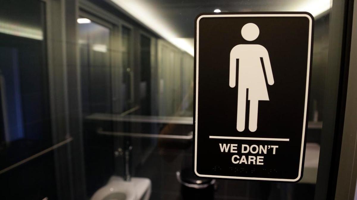 An ADA-compliant bathroom sign designed by artist Peregrine Honig graces a restroom at the 21c Museum Hotel in Durham, N.C.