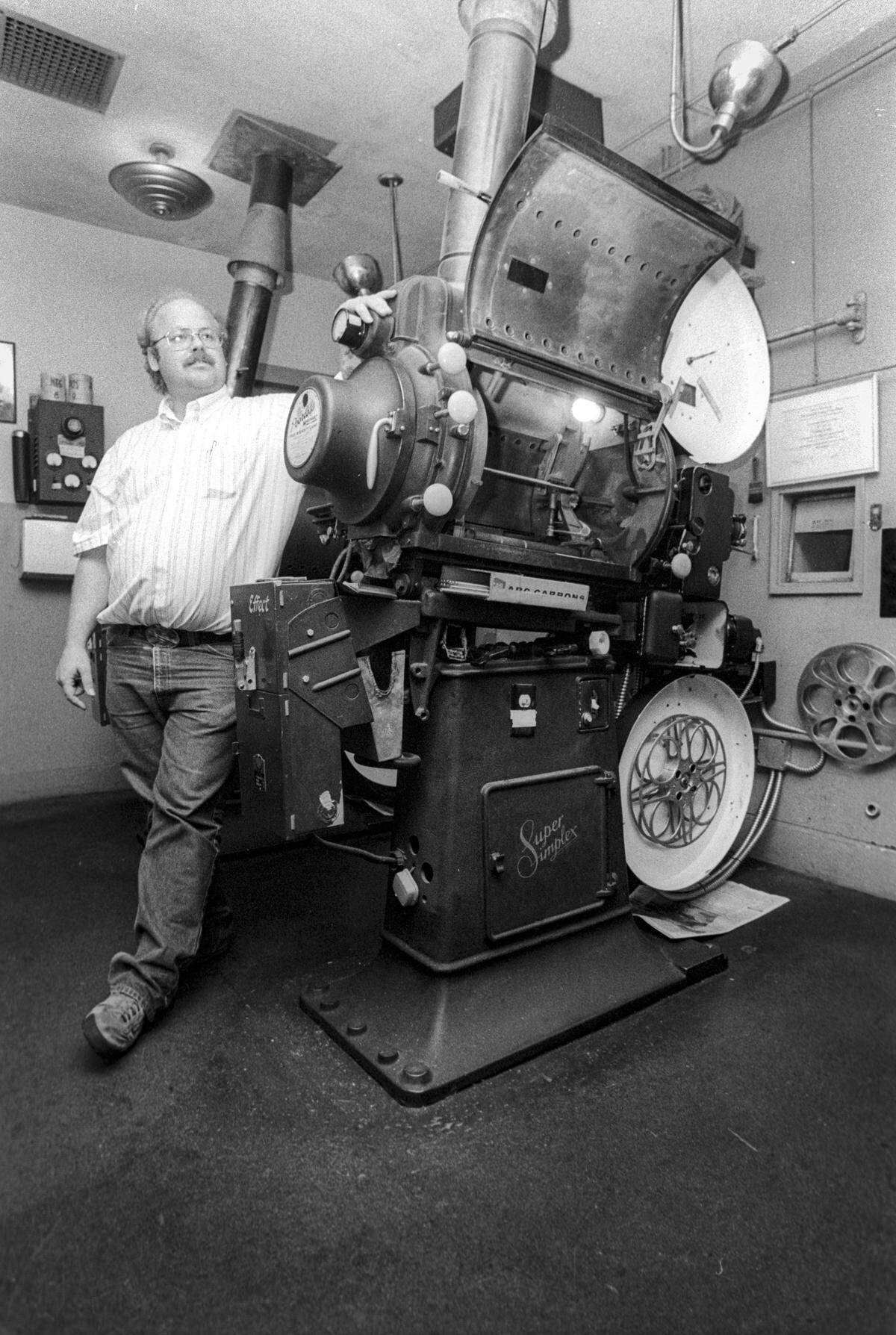 Mark Wardell, head projectionist at the Fremont Theater, leans against one of the two carbon-arc projectors to be replaced after 48 years in service. Some of the last carbon-arc projectors in service were about to be replaced at the Fremont Theater in San Luis Obispo, seen here on Oct. 2, 1990.