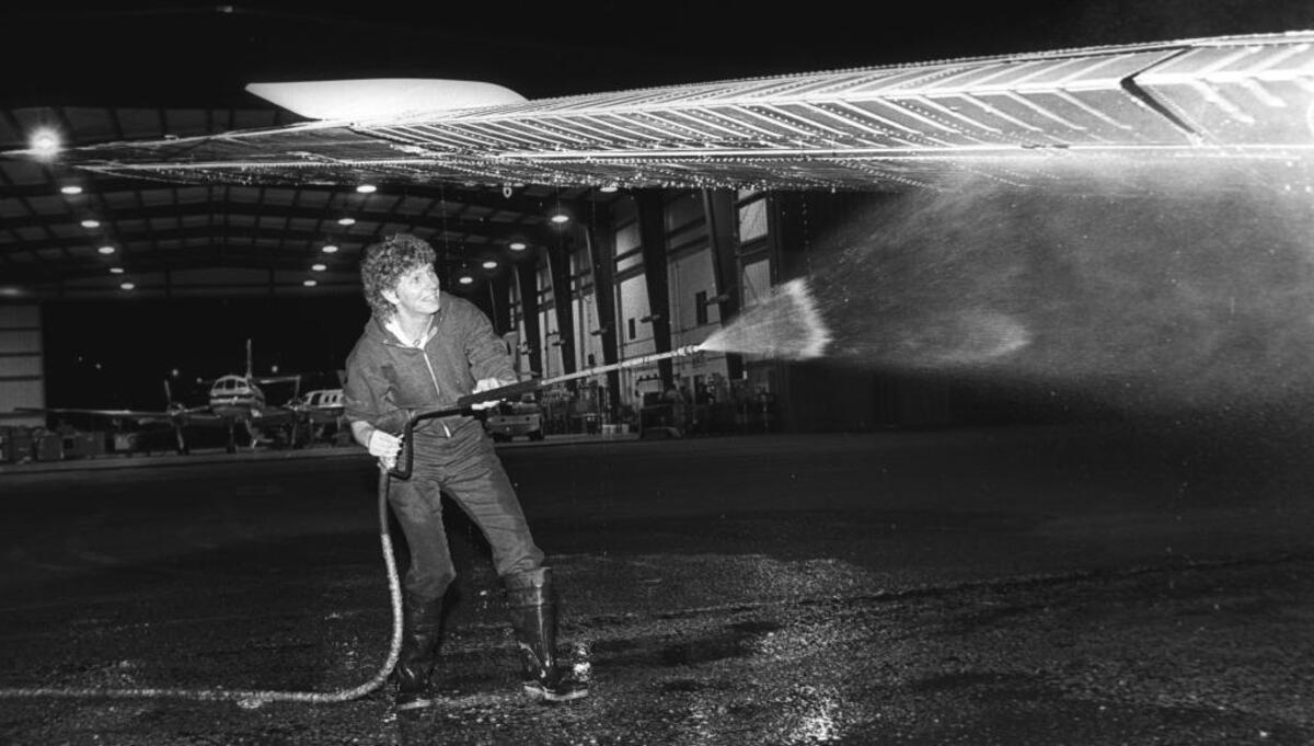 1987: Beth Silva sprays the wing of a plane while washing it outside a giant hangar at McChesney Field in San Luis Obispo on Nov. 19, 1987. The maintenance crew works nightly shifts that begin at 9:30 p.m. Wings West/American Eagle once had headquarters in San Luis Obispo with 250 employees.