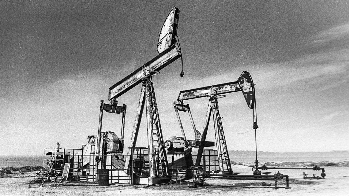 Drilling rigs stand in a Unocal oil field in the Guadalupe Dunes in 1989. The field was shut down in 1994 because a chemical used to help extract the thick, asphalt-like oil product was contaminating nearby areas.