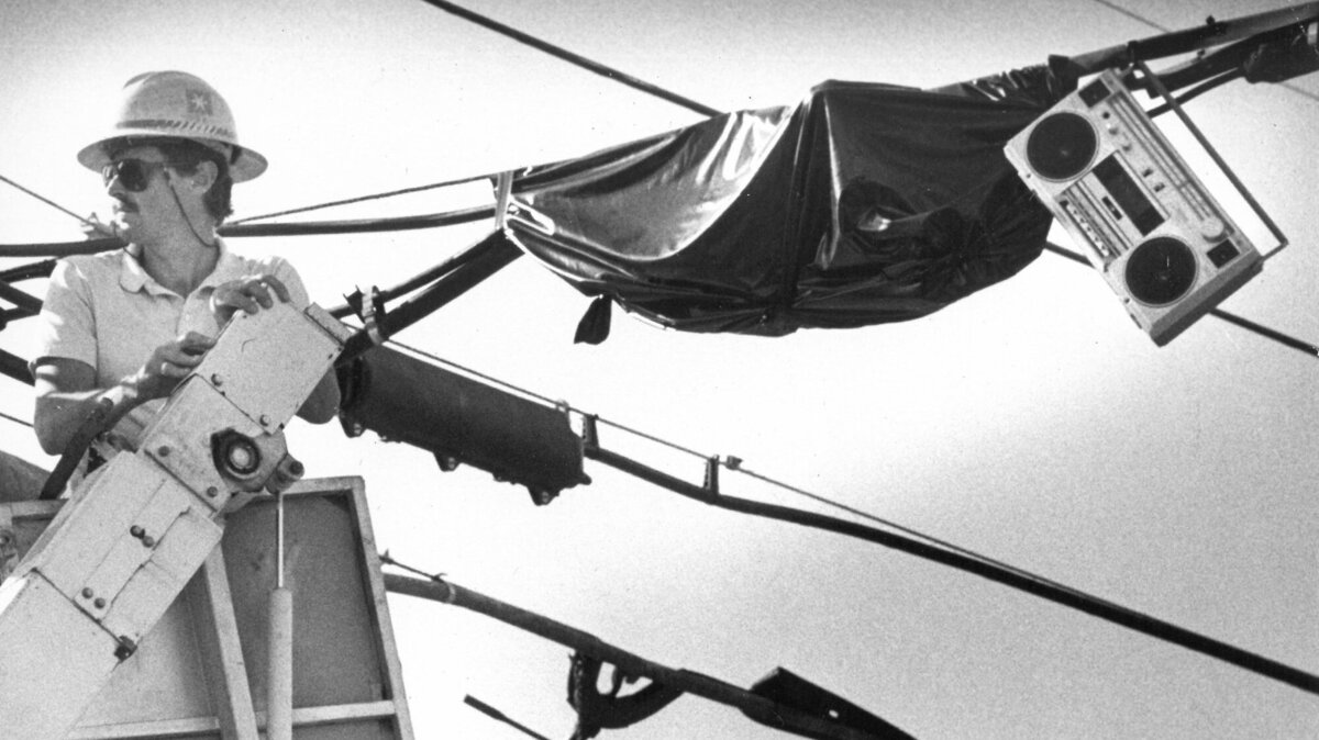 Dave Moore, a splicer for Pacific Bell, takes his listening pleasure with him on the job in this Nov. 13, 1989, photo. Earphones aren’t convenient under a hardhat, so Moore lugged his portable radio up 30 feet high and hung it from a convenient wire. He was working at the corner of Pismo and Santa Rosa Streets in San Luis Obispo.
