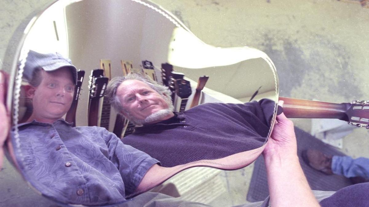 Don Young, left, in his trademark engineers cap and McGregor Gaines at National Resophonic-Guitars shop in San Luis Obispo in 2000. Many National guitar fans say Young and McGregor's work exceeds the quality of vintage models.