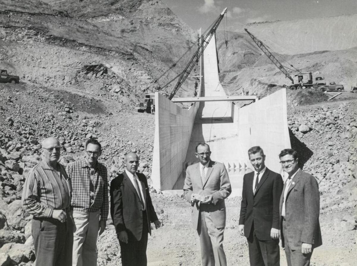 San Luis Obispo city officials and state representatives in 1960 inspect the nearly completed multimillion-dollar Whale Rock dam near Cayucos. Two large cranes assist in the bridge work across the 1,040-foot spillway in the background. From left are Charles F. Beatie, Whale Rock dam construction manager; Robert Jansen, principal hydraulic engineer for the state Department of Water Resources; San Luis Obispo Mayor Fred M. Waters; City Council members Dr. J. Barry Smith, Gerald W. Shipsey and Donald Q. Miller. Published Oct. 5, 1960.