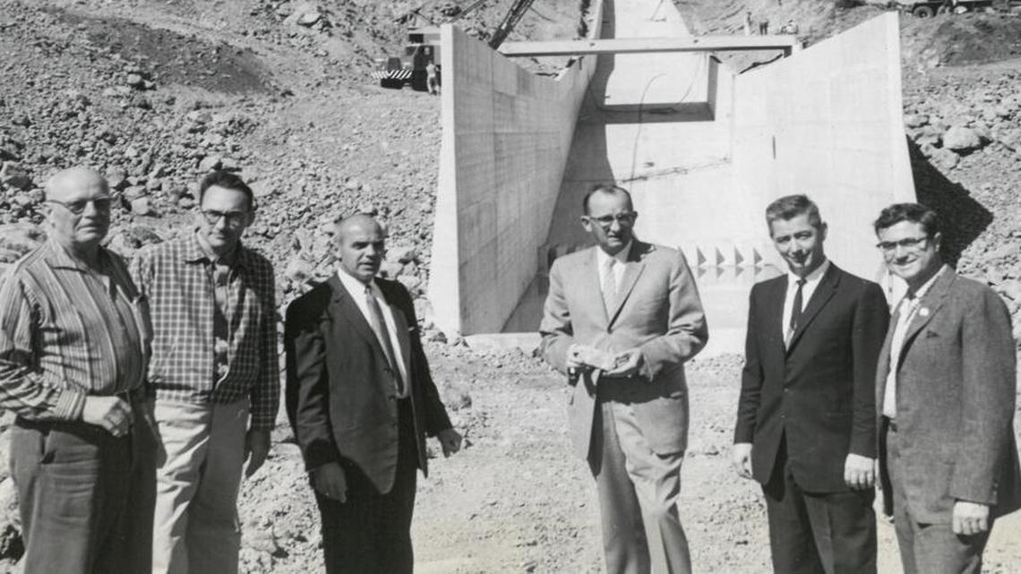 San Luis Obispo city officials and state representatives in 1960 inspect the nearly completed multi-million-dollar Whale Rock dam near Cayucos. Two large cranes assist in the bridge work across the 1,040-foot spillway in the background. From left are Charles F. Beatie, Whale Rock dam construction manager; Robert Jansen, principal hydraulic engineer for the state Department of Water Resources; San Luis Obispo Mayor Fred M. Waters; City Council members Dr. J. Barry Smith, Gerald W. Shipsey and Donald Q. Miller. Published Oct. 5, 1960.
