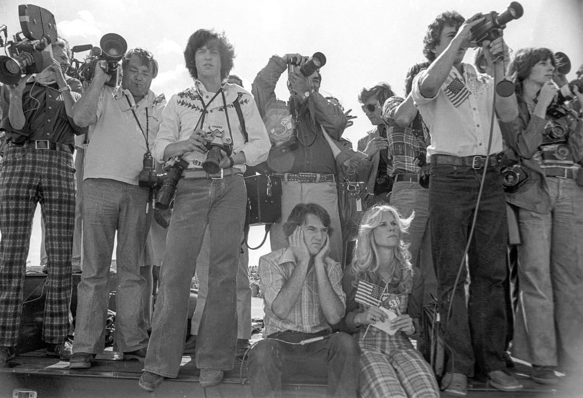 The press wait for President Jimmy Carter to arrive in Fresno to talk about the drought on a day trip to California.
